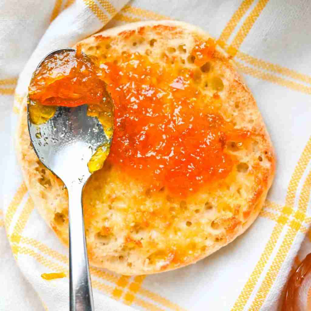 Calamansi Lime Marmalade on crumpet with spoon and yellow white cloth