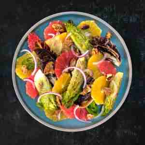 Radicchio orange and red grapefruit salad in a blue bowl