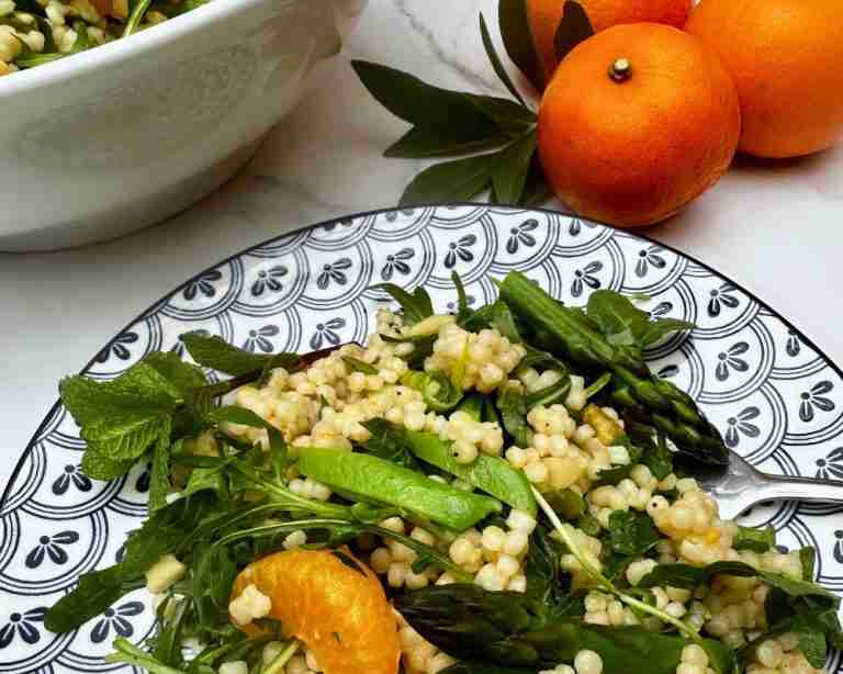 mandarin orange and pearl couscous salad on blue and white plate