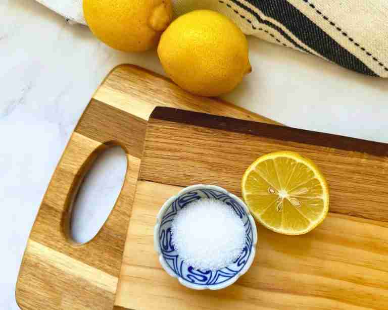 wooden chopping boards with lemons and salt for cleaning