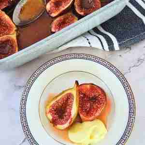honey and orange baked figs on white and gold plate with orage mascarpone creamn