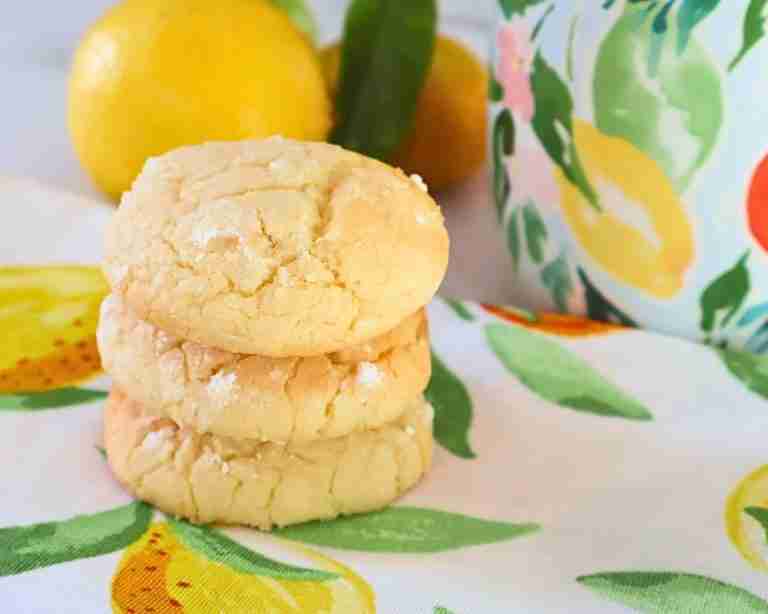 3 lemon macadamia cookies on lemon print napkin with citrus print coffee mug