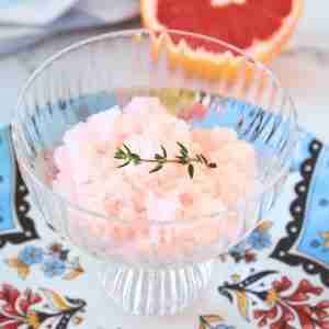 grapefruit granita with vanilla and thyme in glass bowl on blue floral plate