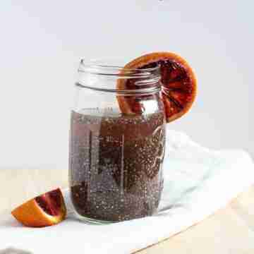 blood orange green tea chia energy drink in mason jar with blood orange garnish
