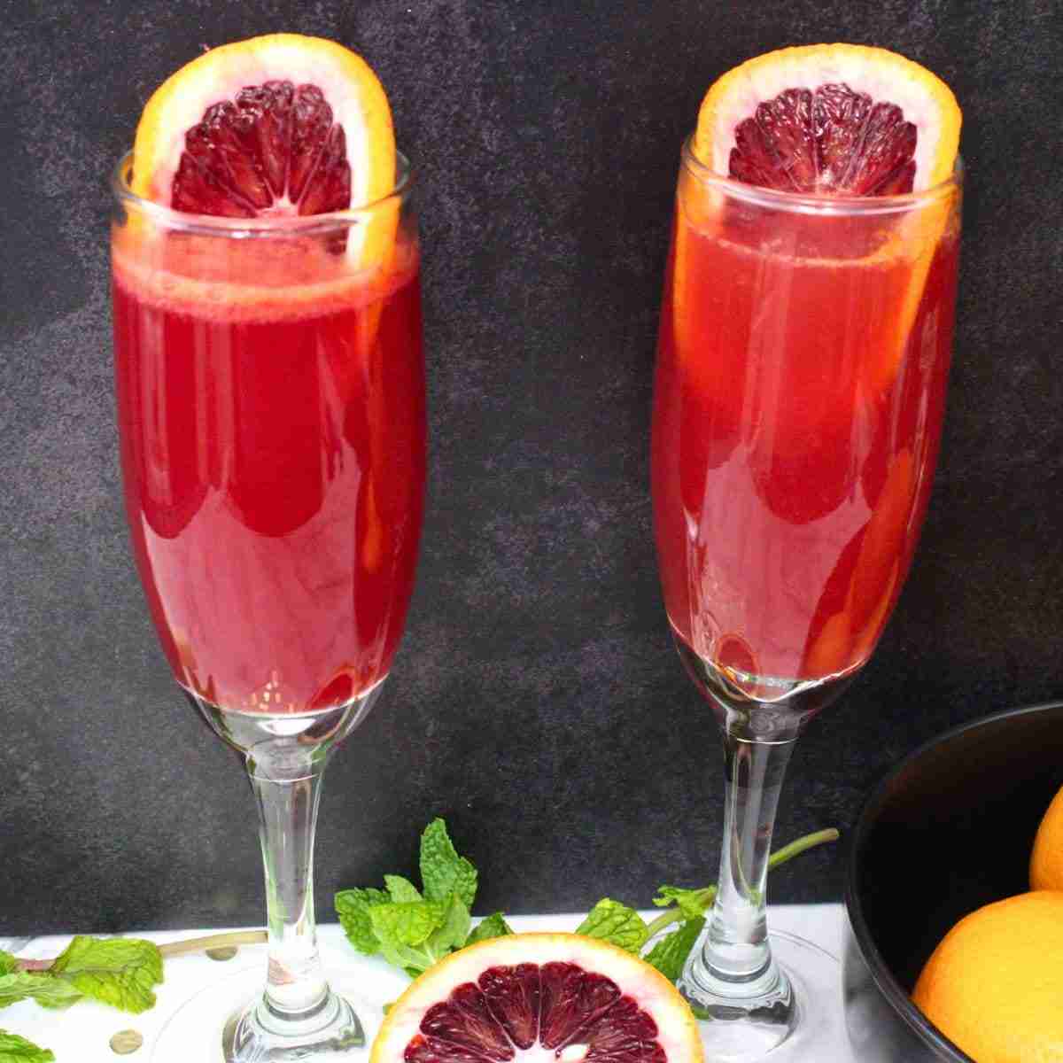 blood orange mimosa in champagne glasses