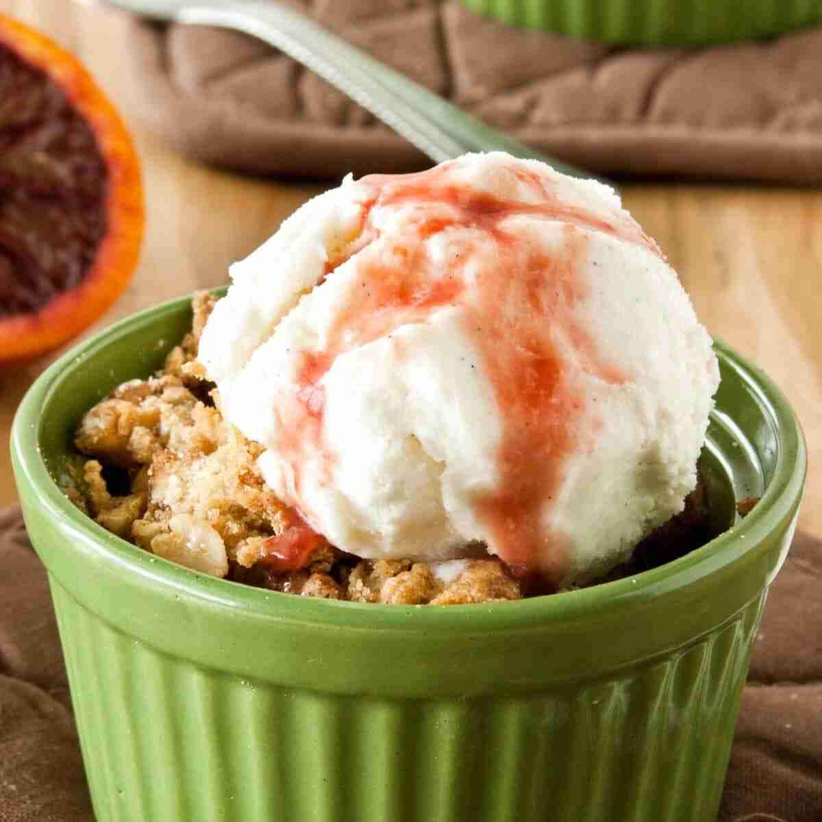 Pear crisp with blood orange sauce in green dish