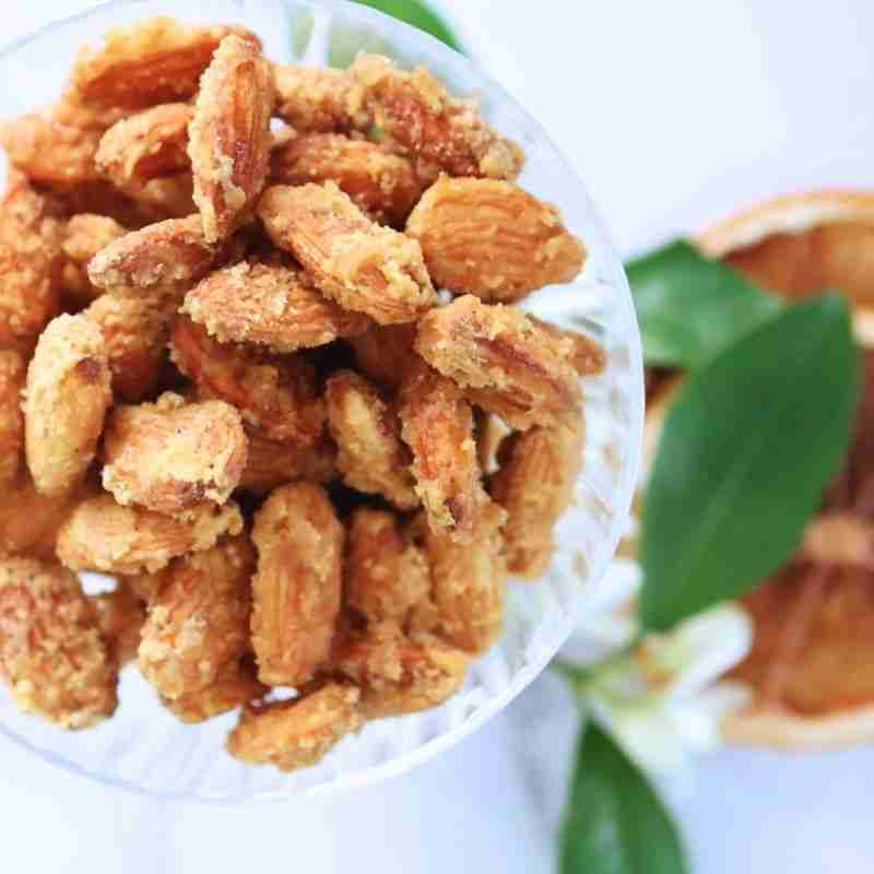 sugar coated orange candied almonds in glass dish