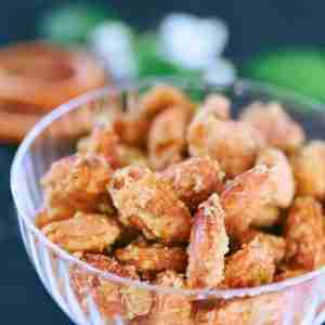 orange candied almons with cinnamon in glass dish with dried orange slices