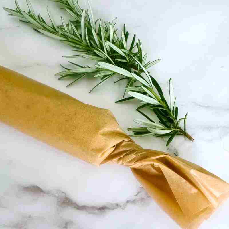compopudn orange butter rolled in parchment with fresh rosemary