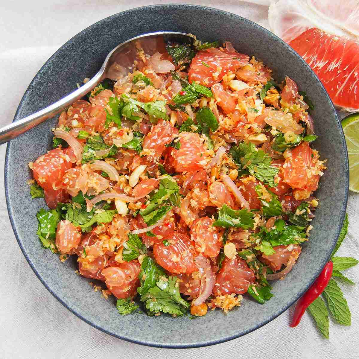 Thai pome,o salad in grey ceramic bowl wth chili and mint