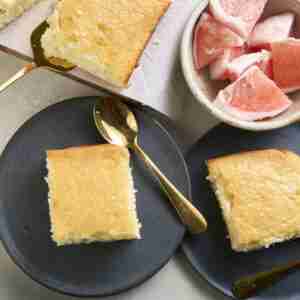 pomelo cake on plate with bowl of pink pomelo segments