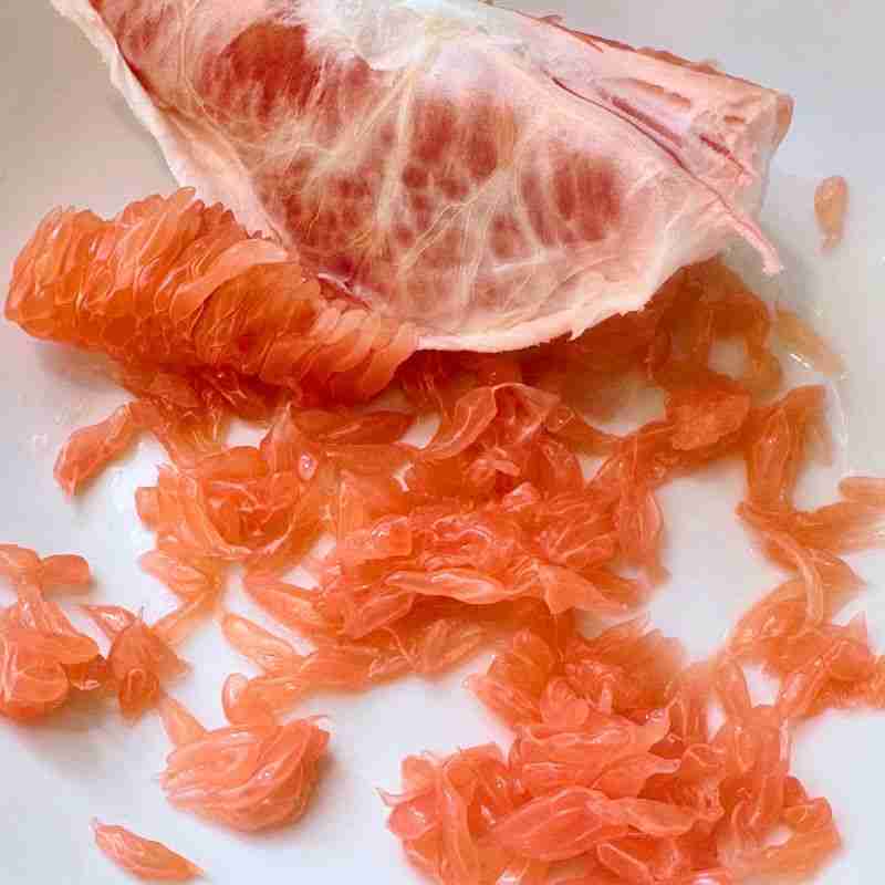 Pomelo segment broken into juice vesicles or 'pearls'