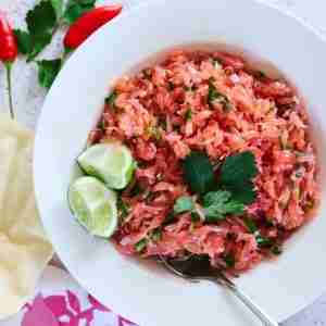 spicy pomelo salad with cilantro and chili with kime wedges in white bowl